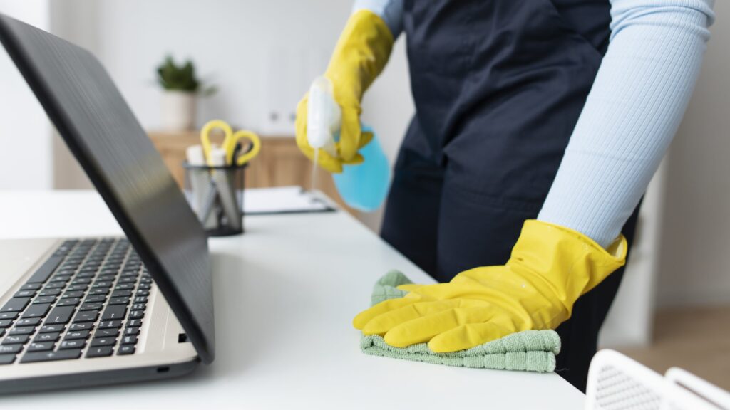 Aphrodite Cleaning Co Wiping A Desk with Gloves